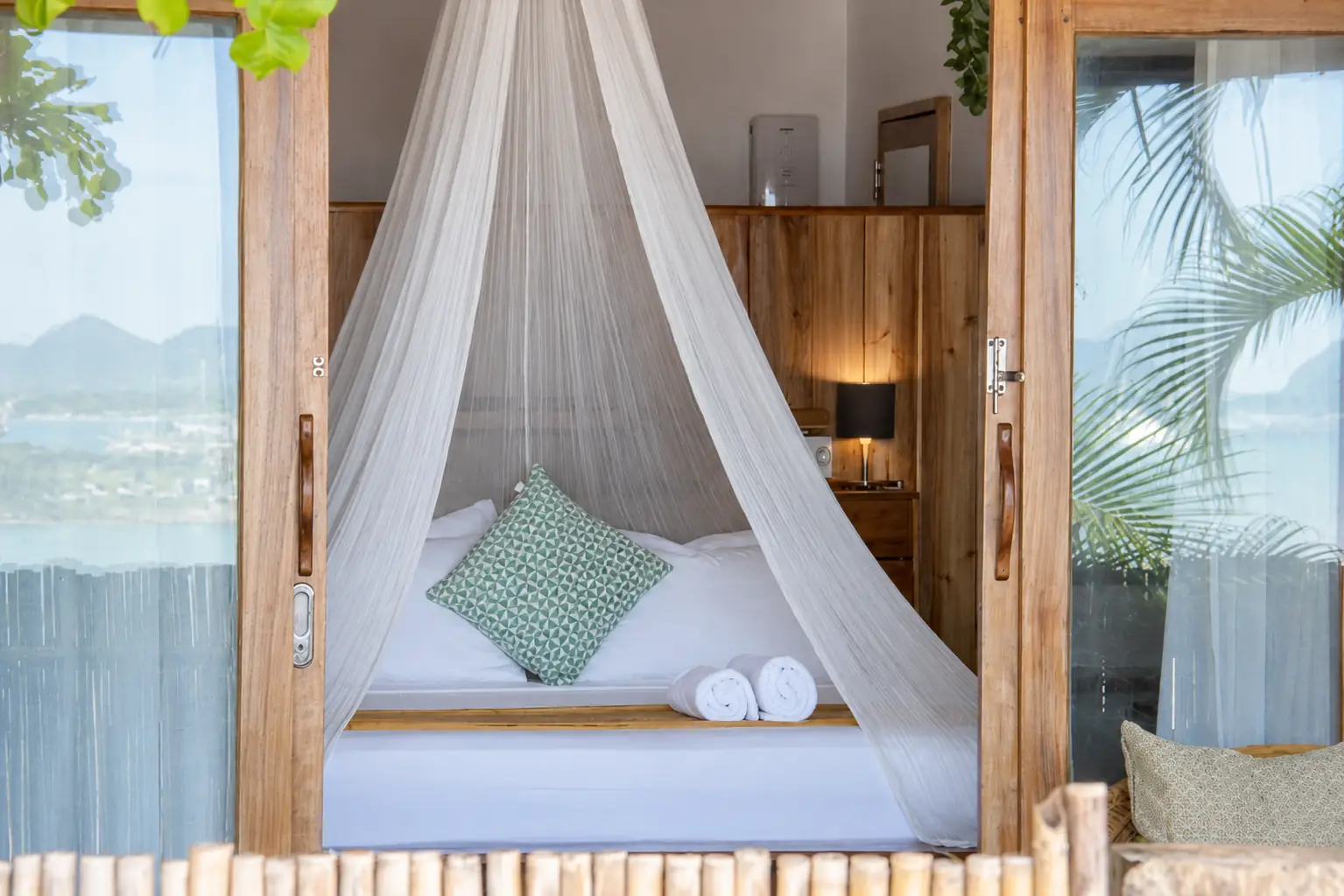 Bungalow bed with mosquito net and wooden interior